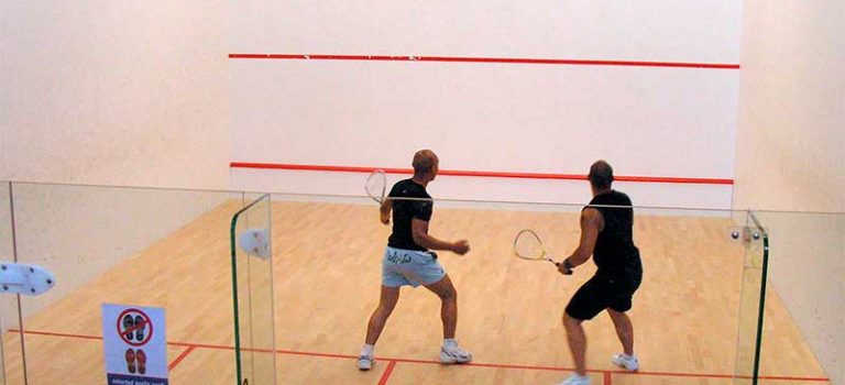 Two athletes playing squash