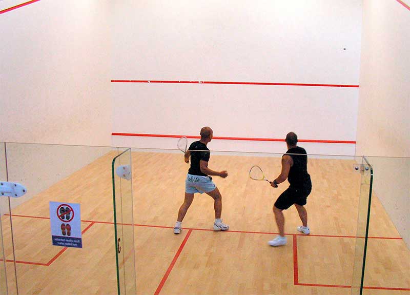 Two athletes playing squash